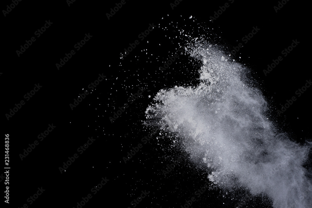 White powder explosion on black background. Dust splatted isolated. Paint Holi. White powder explosion on black background. Dust splatted isolated. Paint Holi.