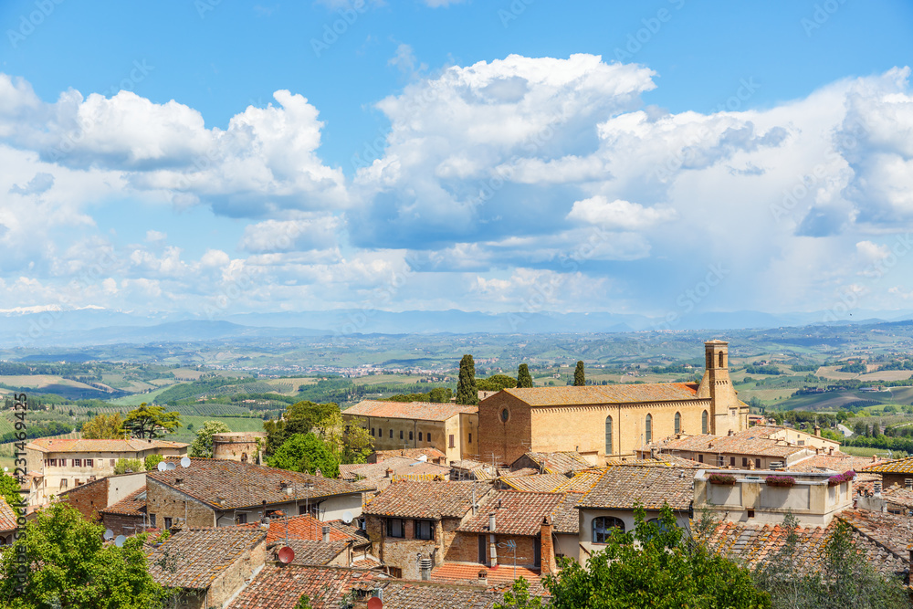 View the rooftops of the city of San Gimignano and the Tuscany countryside