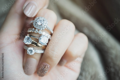 Close up of an elegant diamond rings on woman finger.love and wedding concept.soft and selective focus. photo