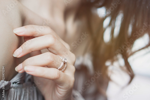 Blurry of an elegant diamond ring on woman finger. soft and selective focus. Love and wedding concept.