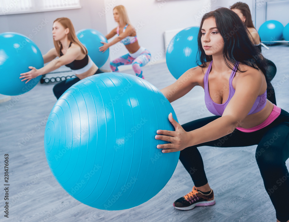 Young fitness women with blue fitballs. Crossfit training. Young fitness women with blue fitballs. Crossfit training.
