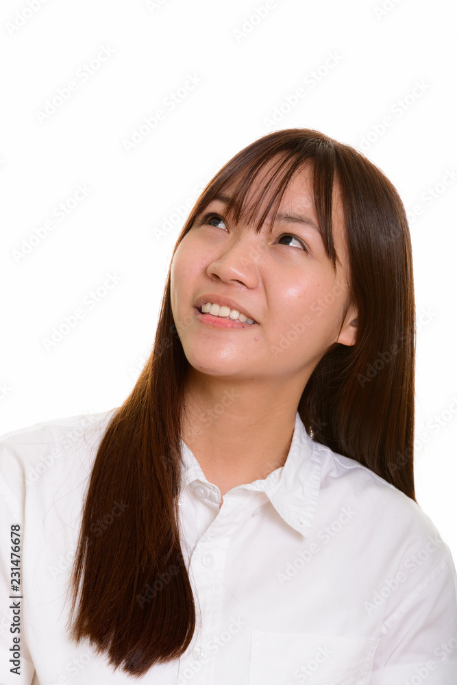 Young happy Asian teenage girl smiling and thinking Young happy Asian teenage girl smiling and thinking