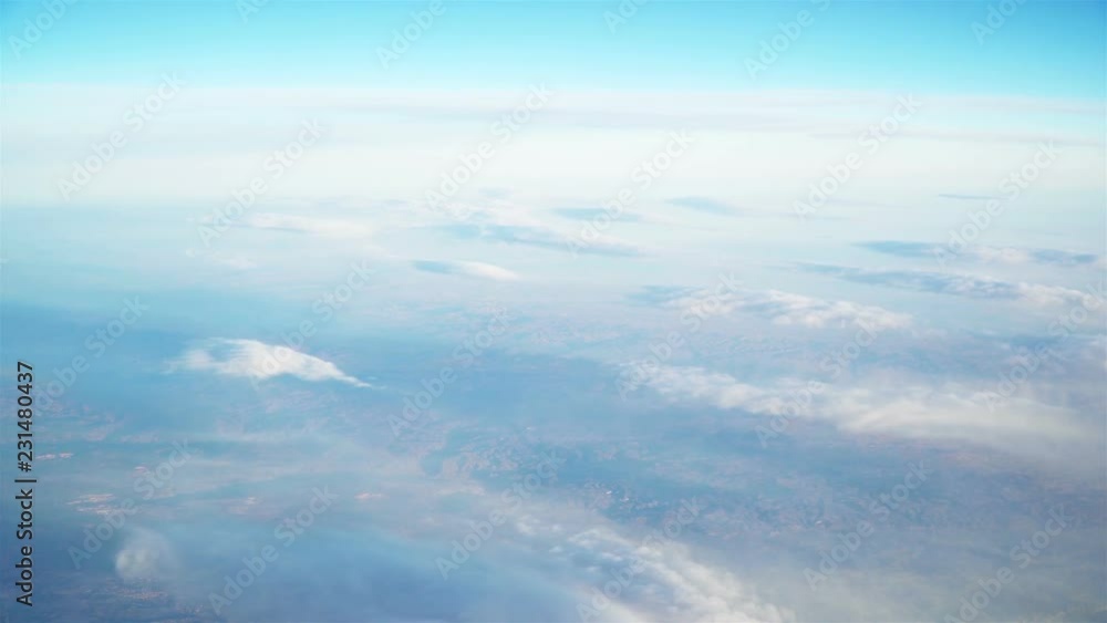 Airplane flying above the clouds in blue sky at daytime Airplane flying above the clouds in blue sky at daytime