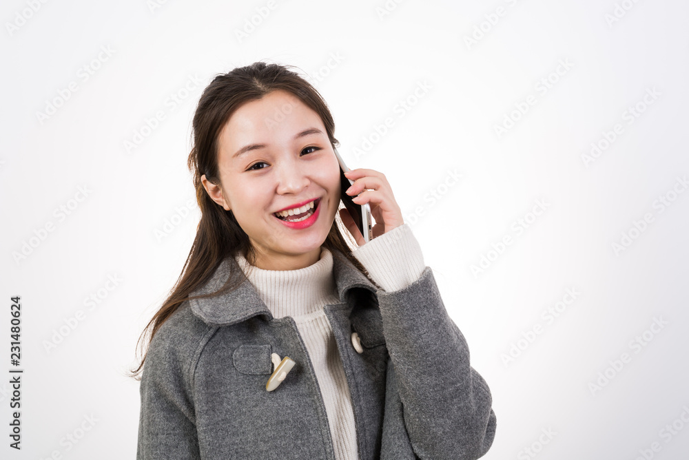 Young happy woman speaks on the phone, studio shot. Young happy woman speaks on the phone, studio shot.