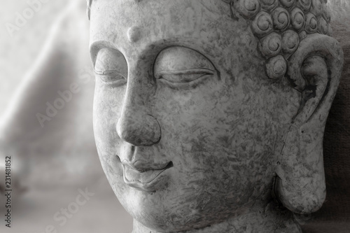 macro detail of buddha goddess head on stone in gray color