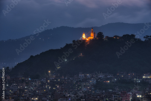 View of Stupa in Swayambhunath Monkey temple and vicinity of house at twilight in Kathmandu, Nepal.