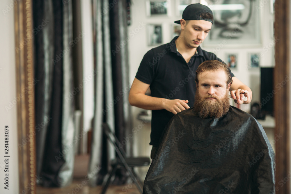 Male client getting haircut by hairdresser. barbershop Male client getting haircut by hairdresser. barbershop