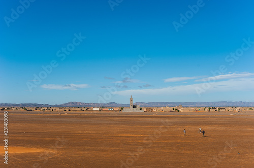View from the dunes to the city Merzouga in Morocco, Africa