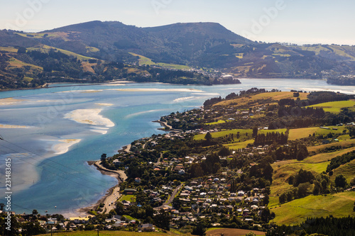 Fotografie Dunedin town and bay as seen from the hills above, South Island, New Zealand