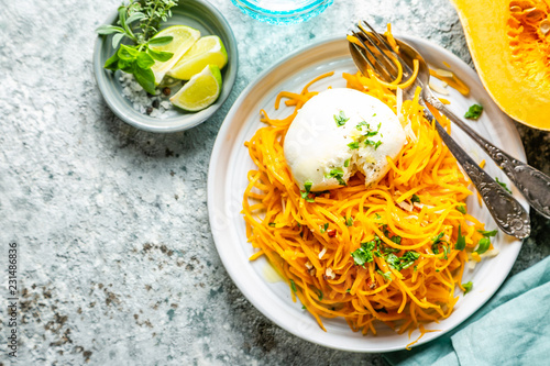 Butternut squash noodles with mozzarela, pecans, herbs, copy space photo