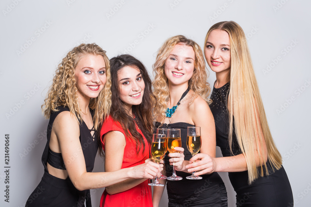 Party, holidays, celebration and new year eve concept - Cheerful young woman with glasses of champagne at the party Party, holidays, celebration and new year eve concept - Cheerful young woman with glasses of champagne at the party