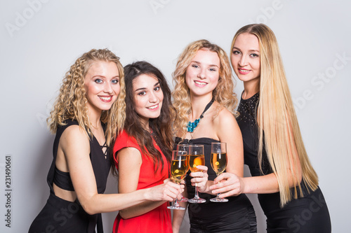 Party, holidays, celebration and new year eve concept - Cheerful young woman with glasses of champagne at the party