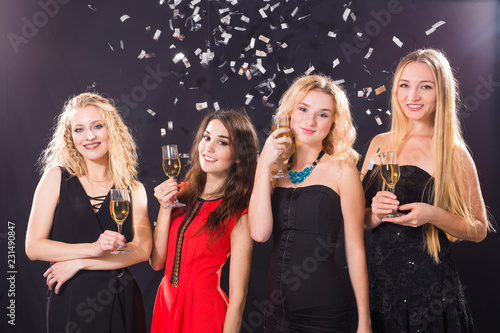 Party, holidays, celebration and nightlife concept - smiling female friends with glasses of champagne in club