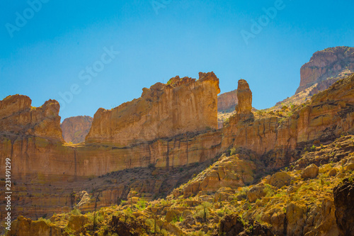 The sheer red and orange cliffs surround Canyon Lake in the wilderness desert east of Phoenix Arizona cliffs reach to the sky in this natural surrounding