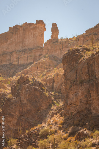 The sheer red and orange cliffs surround Canyon Lake in the wilderness desert east of Phoenix Arizona cliffs reach to the sky in this natural surrounding