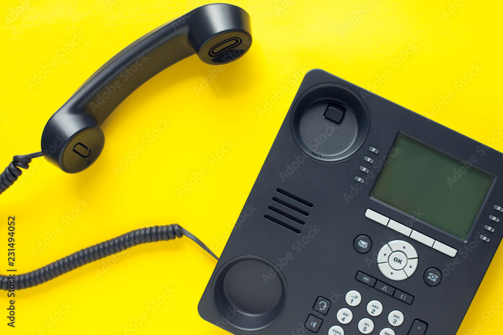 Deskphone, office and business concept. New ip phone with buttons and big display for communication without interference. Top view. Space for a text. Close up. Deskphone, office and business concept. New ip phone with buttons and big display for communication without interference. Top view. Space for a text. Close up.