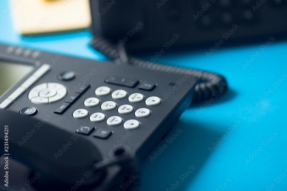 Deskphone, office and business concept. New ip phone with buttons and big display for communication without interference. Top view. Space for a text. Close up.