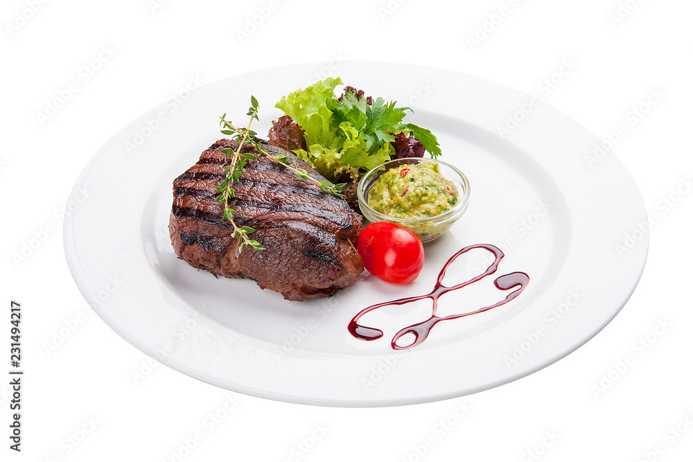 Beef steak with Guacamole sauce. On a white plate