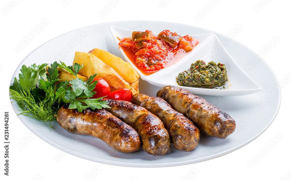 Homemade sausages with potatoes and sauce. On a white plate