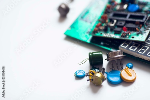 Microprocessor concept. Set of drivers, diodes, capacitors, inductance and other micro electronics on the white background. Top view. Space for a text. Close up. photo