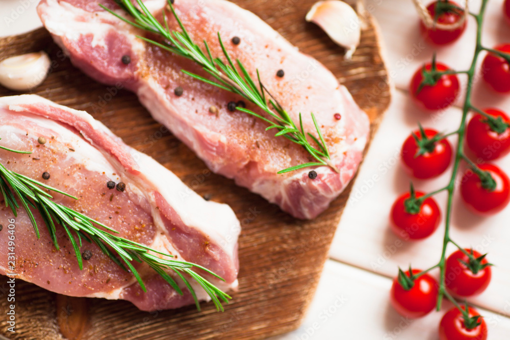 Fresh raw pork on the cutting board with ingredients for cooking. Food, flat lay, recipes and nutrition concept. Top view. Close up. Fresh raw pork on the cutting board with ingredients for cooking. Food, flat lay, recipes and nutrition concept. Top view. Close up.