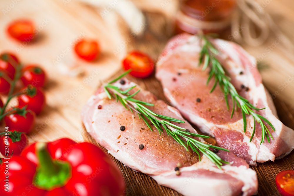 Fresh raw pork on the cutting board with ingredients for cooking. Food, flat lay, recipes and nutrition concept. Top view. Close up. Fresh raw pork on the cutting board with ingredients for cooking. Food, flat lay, recipes and nutrition concept. Top view. Close up.