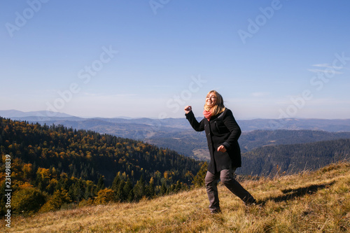 Woman dancing in mountains © Mykola Komarovskyy
