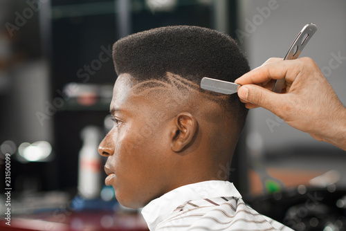 Side view of man with stylish haircut in barber shop