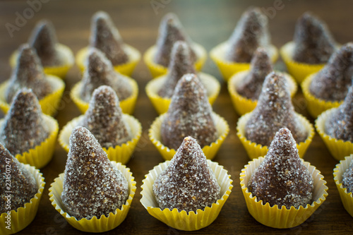 delicious Brazilian sweets called cajuzinho - blend of condensed milk with peanuts and chocolate photo