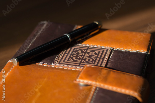 Ready-to-work business accessories: fountain pen and diary in focus