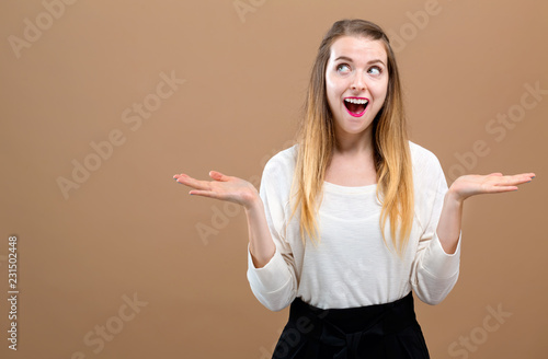 Happy young woman on a brown background