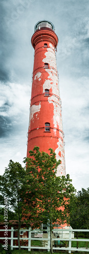 Low angle panorama of an old and eroded Pakri lighthouse. photo