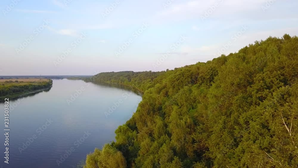 River with trees on the shore in the sunlight, aerial shot River with trees on the shore in the sunlight, aerial shot