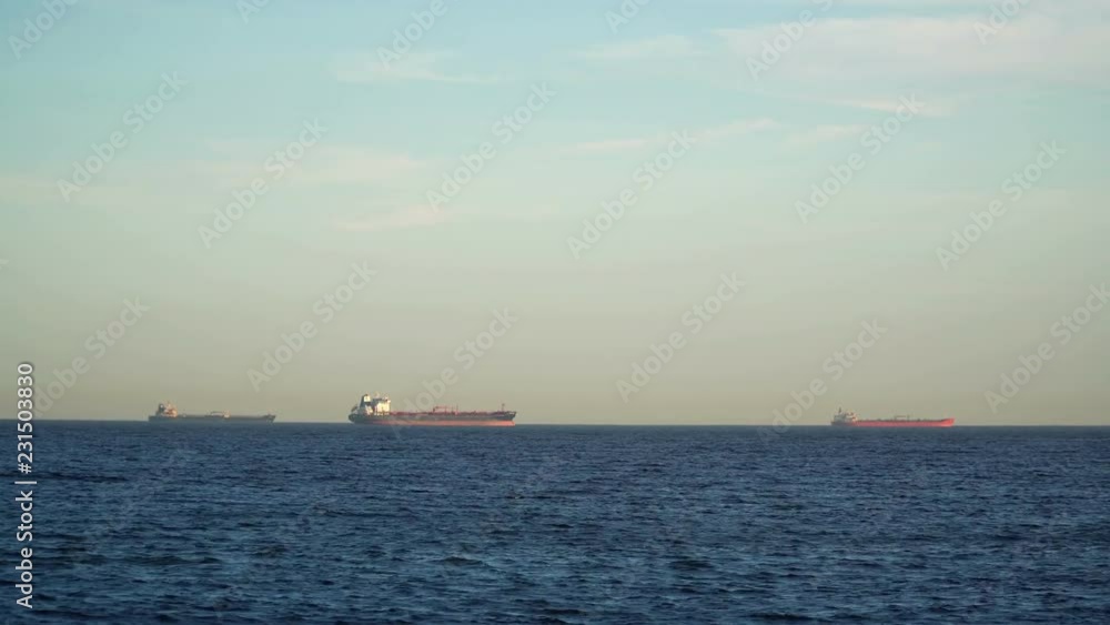 Cargo Tanker Ships Sailing across the Ocean at Sunset Cargo Tanker Ships Sailing across the Ocean at Sunset
