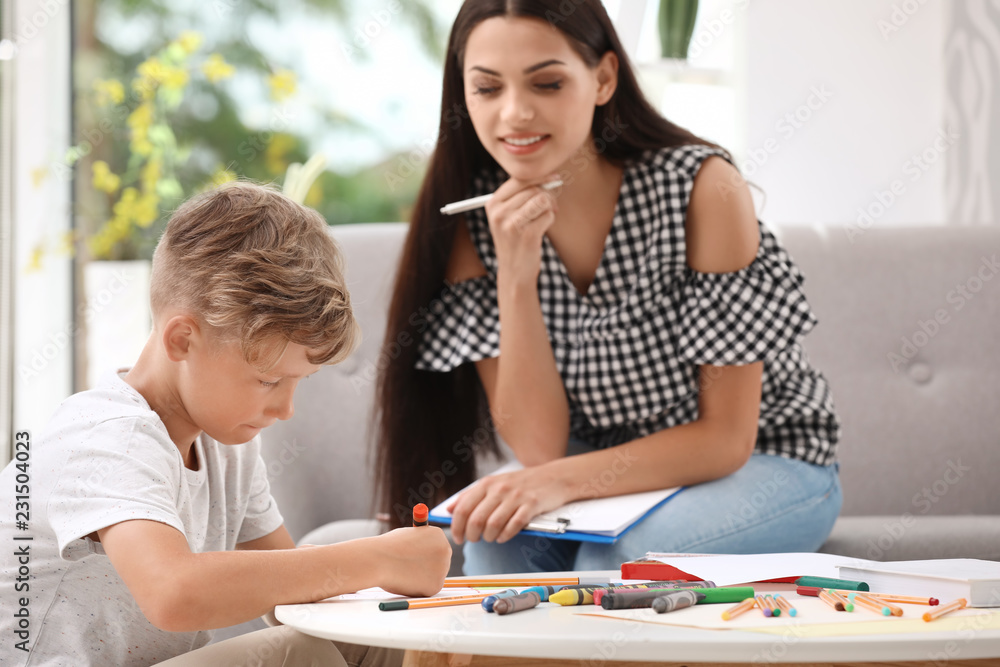 Young female psychologist working with little child in office Young female psychologist working with little child in office