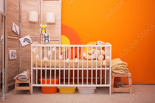 Fototapeta Naklejka Na Ścianę i Meble -  Baby room interior with crib near color wall