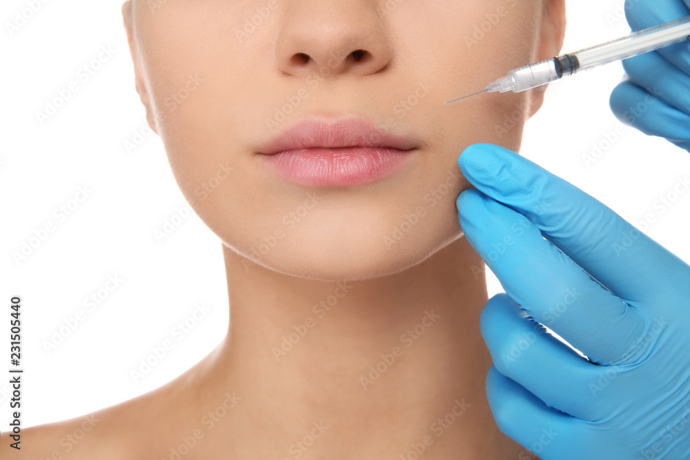 Young woman getting facial injection on white background, closeup. Cosmetic surgery concept Young woman getting facial injection on white background, closeup. Cosmetic surgery concept