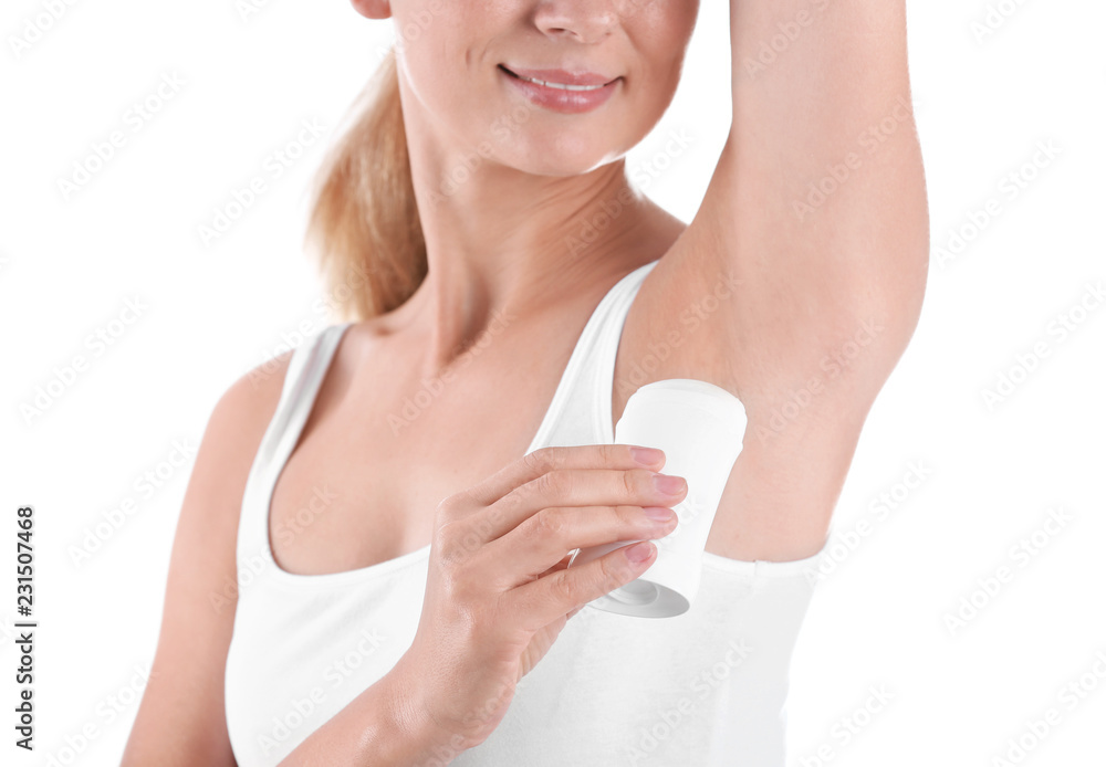 Young woman using deodorant on white background, closeup Young woman using deodorant on white background, closeup