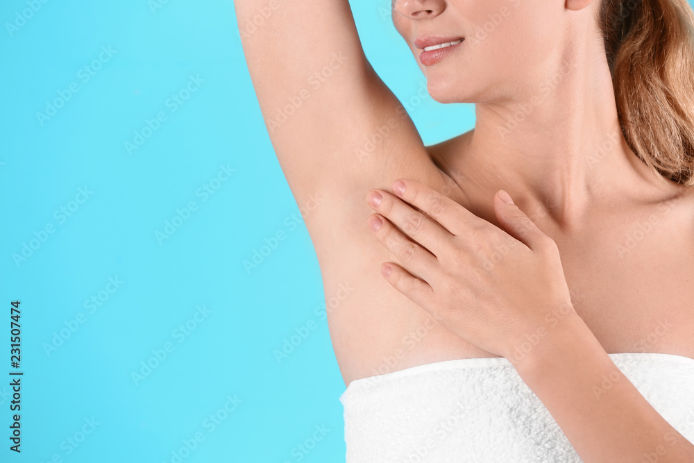Young woman showing armpit on color background, space for text. Using deodorant Young woman showing armpit on color background, space for text. Using deodorant