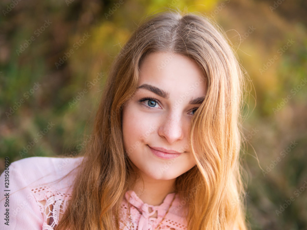Portrait of a cute girl with a beautiful smile at sunset Portrait of a cute girl with a beautiful smile at sunset