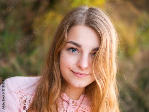 Portrait of a cute girl with a beautiful smile at sunset