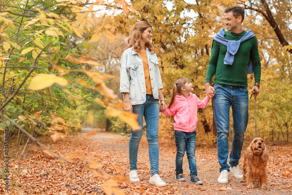 Happy family with child and dog in park. Autumn walk Happy family with child and dog in park. Autumn walk