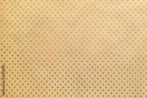 Golden background from metal foil paper with a stars pattern