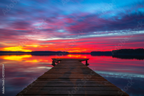 Beautiful colourful sunset with a wooden jetty in the Lake © Mike Mareen