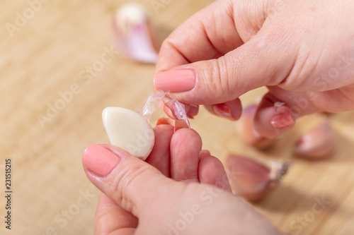 woman cook cleans garlic cloves