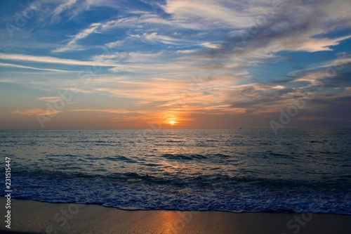 Fotografia, Obraz sunset on the beach with warm breezes and waves on the gulf coast