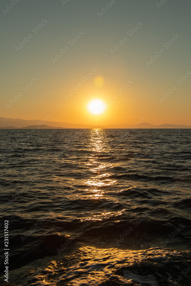 Golden sunset scenery over the horizon on the Mediterranean Sea in Greece - Aegean Sea ant the Northern Sporades - Skiathos, Alonissos