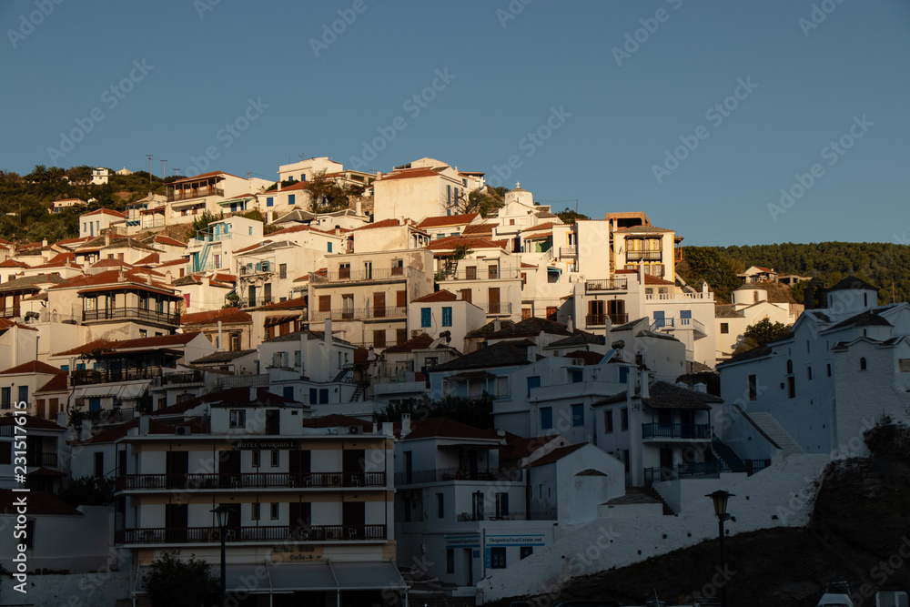 Skopelos Old Town and small greek houses on the hill as seen from the water on a sailing boat or yacht in the harbor