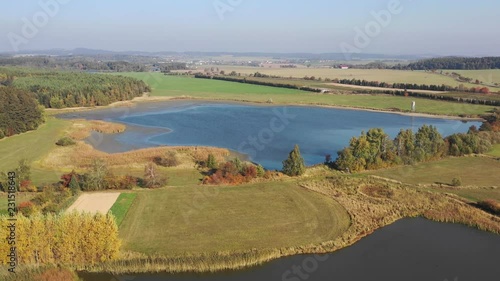 Aerial video of the small dam, reservoir in Europe with forest and fields in neighborough. photo
