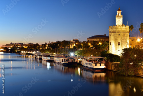 Torre del Oro (Gold Tower) illuminated at night, medieval landmark from early 13th century in Seville, Spain